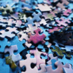 Empty Pursuits Made Eternally Meaningful - Weekly Blog Post by Dr. Craig Biehl - blue and purple puzzle pieces in stack