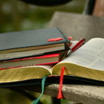 We Depend on God’s Word and Words - Weekly Blog Post by Dr. Craig Biehl - open Bible, journal, notebooks on table