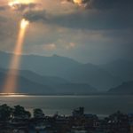 Sought, Saved, and Exalted by God’s Infinite Grace - Japanese homes on bay sunlight shining through clouds