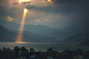 Sought, Saved, and Exalted by God’s Infinite Grace - Japanese homes on bay sunlight shining through clouds