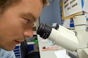 The Limits of Scientists and the Scientific Method - Weekly Blog Post by Dr. Craig Biehl - man looking into microscope