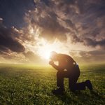 Gleanings from The Religious Affections (Part 21): Distinguishing Sign Six: True Humility Accompanies Gracious Affections - Weekly Blog Post by Dr. Craig Biehl - man kneeling in front of sunset